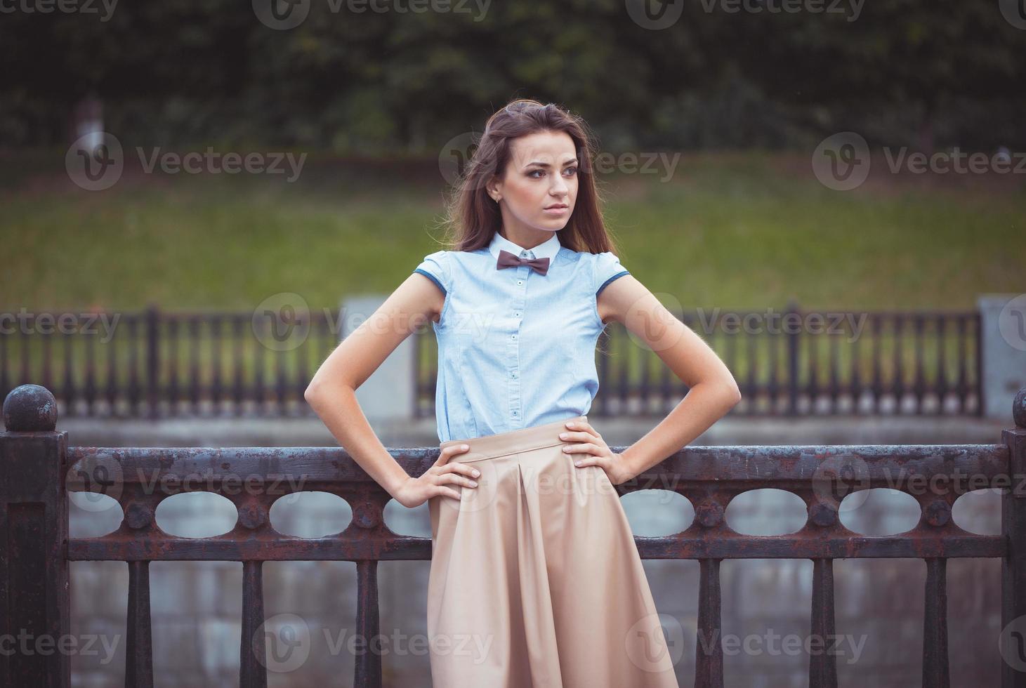 Young beautiful, elegantly dressed woman photo