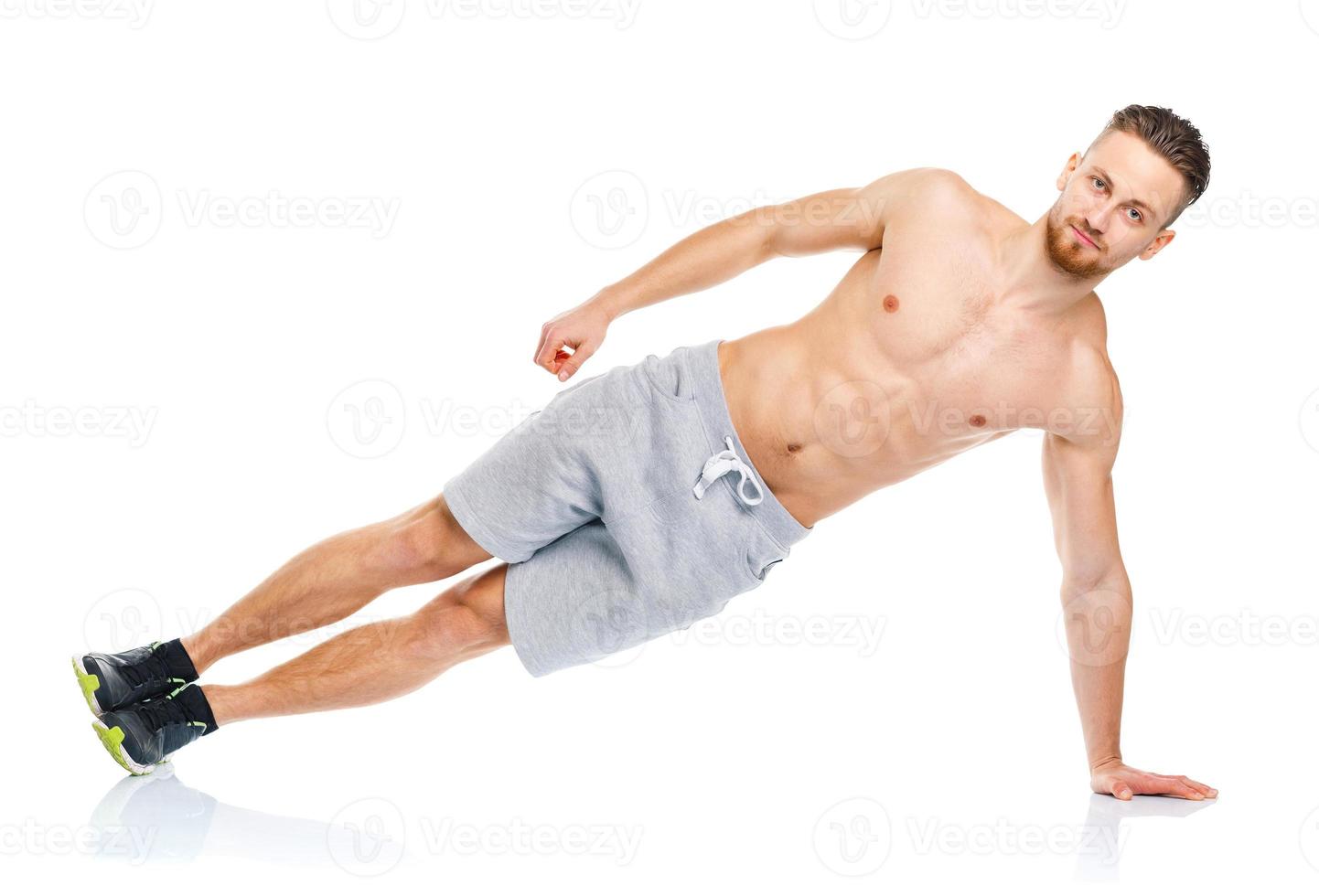 Sport attractive man doing fitness exercises on the white photo