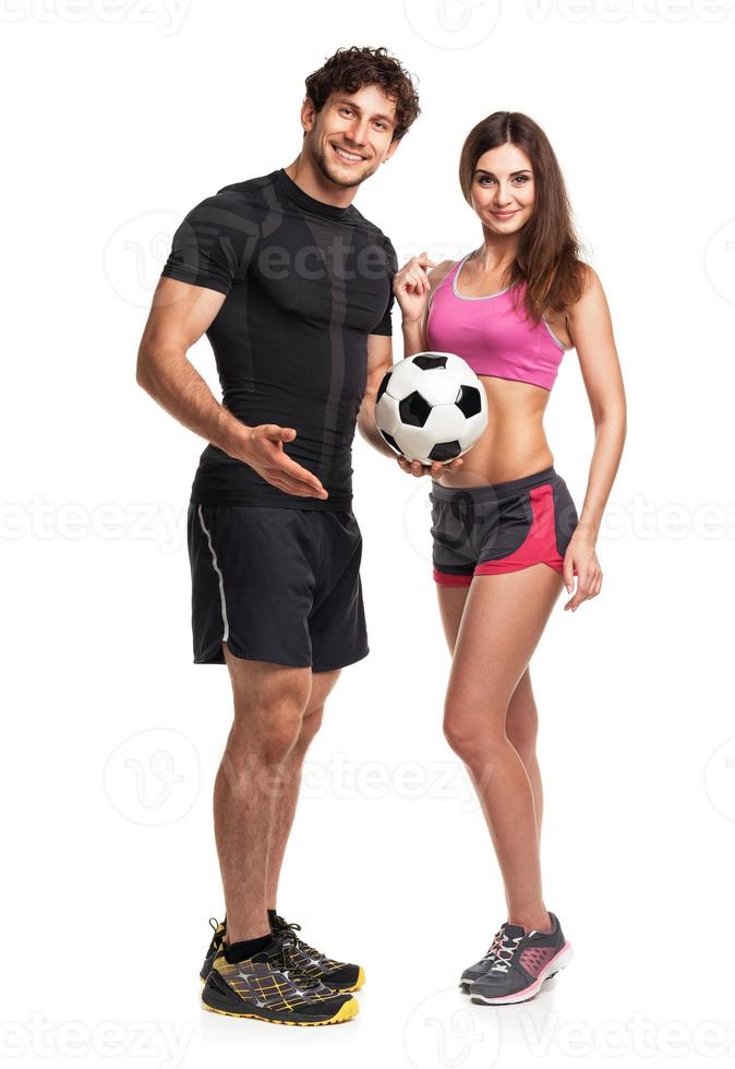 Athletic couple - man and woman with ball on the white photo