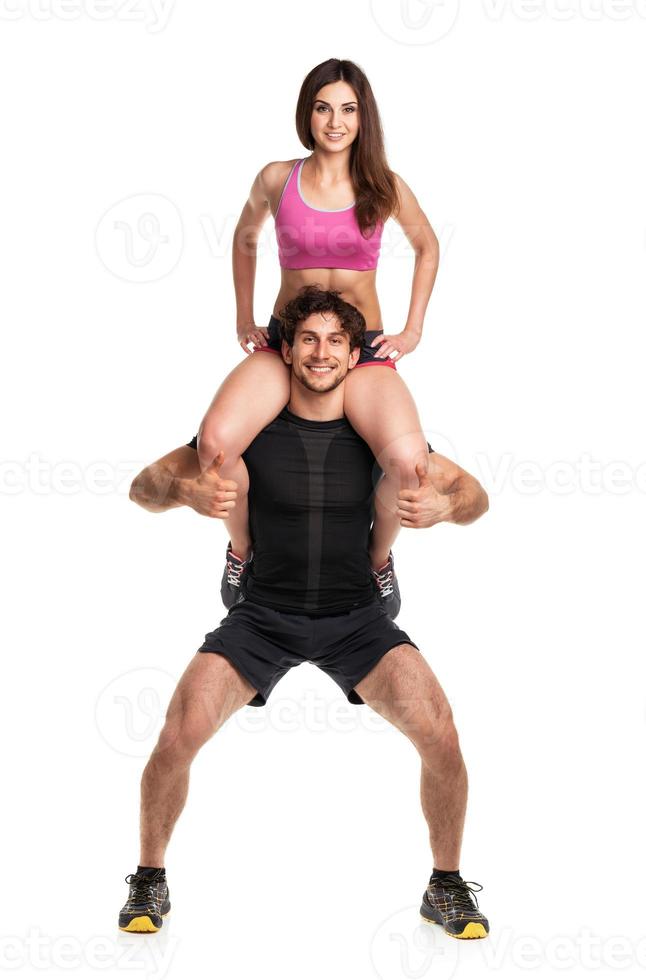 Sports guy holds on shoulder a girl on a white photo