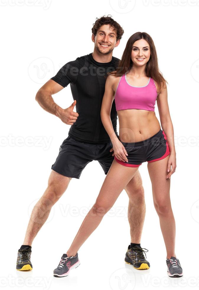 Athletic man and woman after fitness exercise with a finger up on the white photo