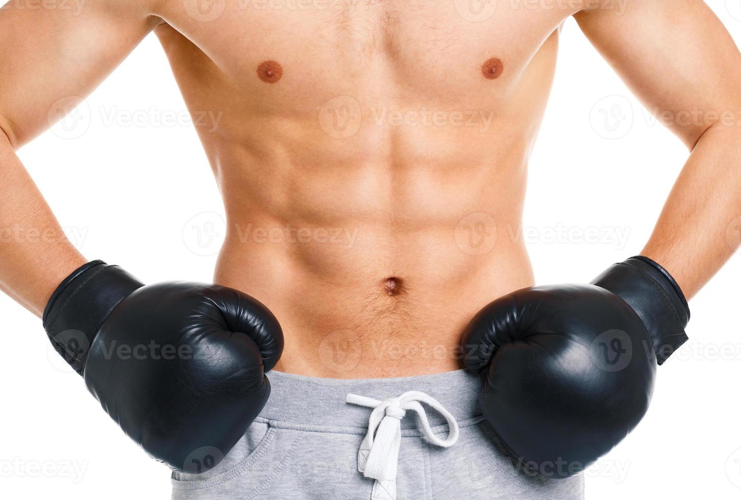 Athletic attractive man wearing boxing gloves on the white photo