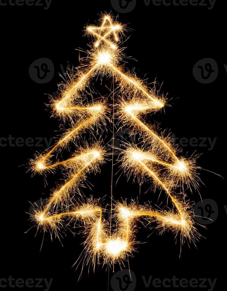 Christmas tree made by sparkler on a black photo