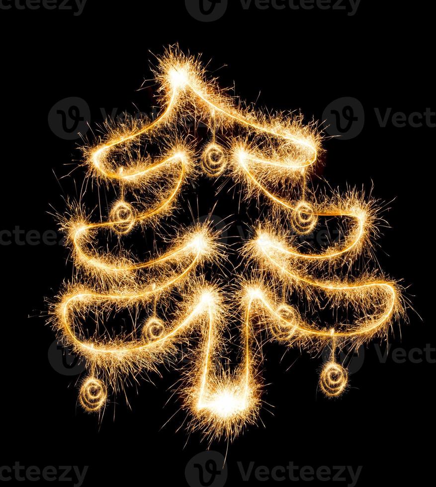 Christmas tree made by sparkler on a black photo