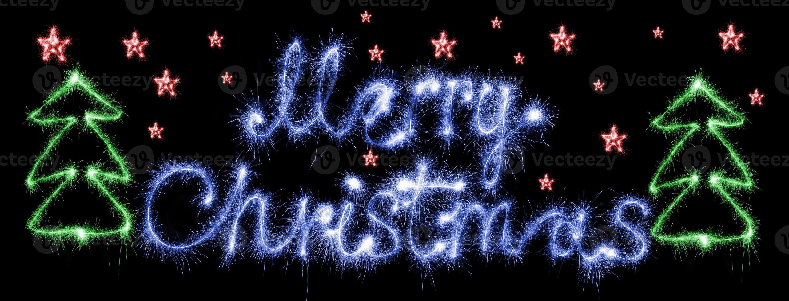 Merry christmas made of sparkles on black photo