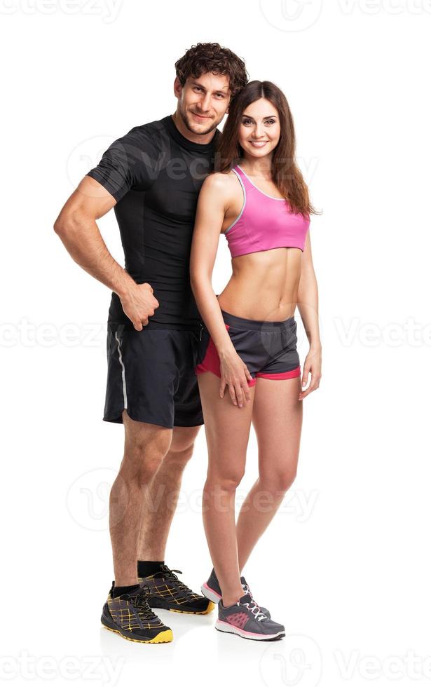 Sport couple - man and woman after fitness exercise on the white photo