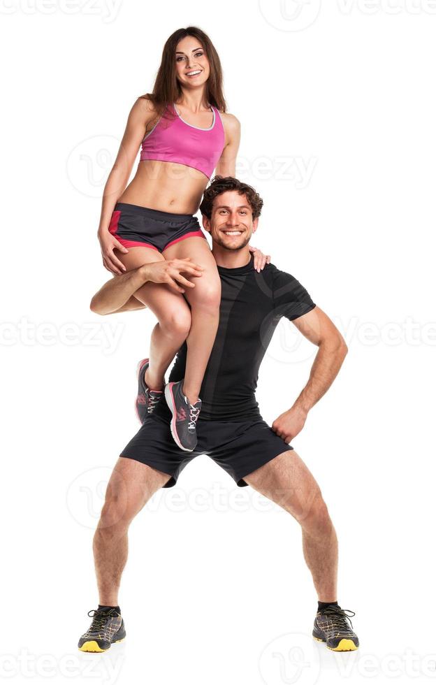 Sports guy holds on shoulder a girl on a white photo