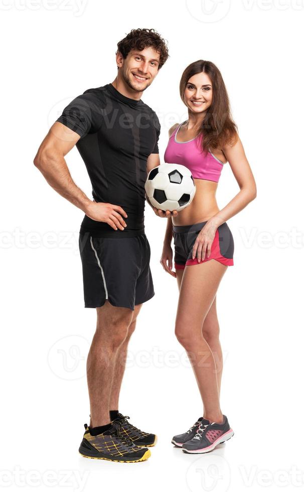 Athletic man and woman with ball on the white photo