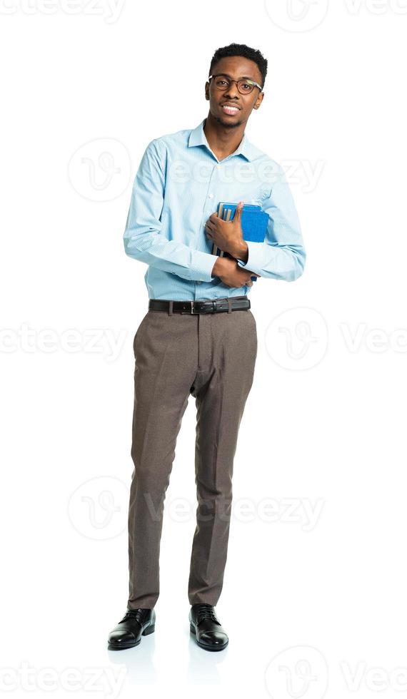 Happy african american college student with books standing on white photo