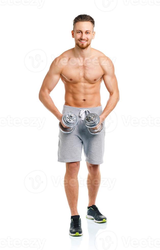 Happy athletic man with dumbbells on the white photo