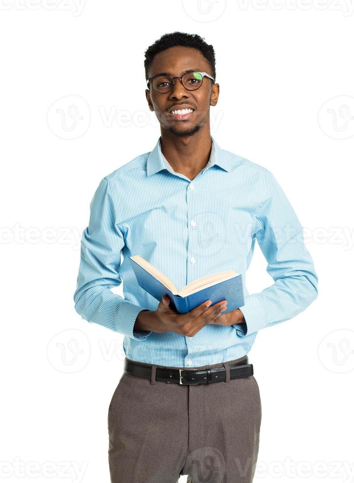 Happy african american college student with books in his hands standing on white photo