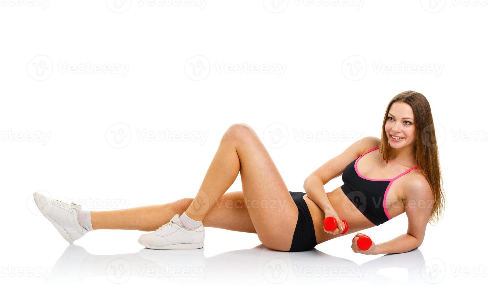 Happy athletic woman with dumbbells doing sport exercise, isolated on white photo