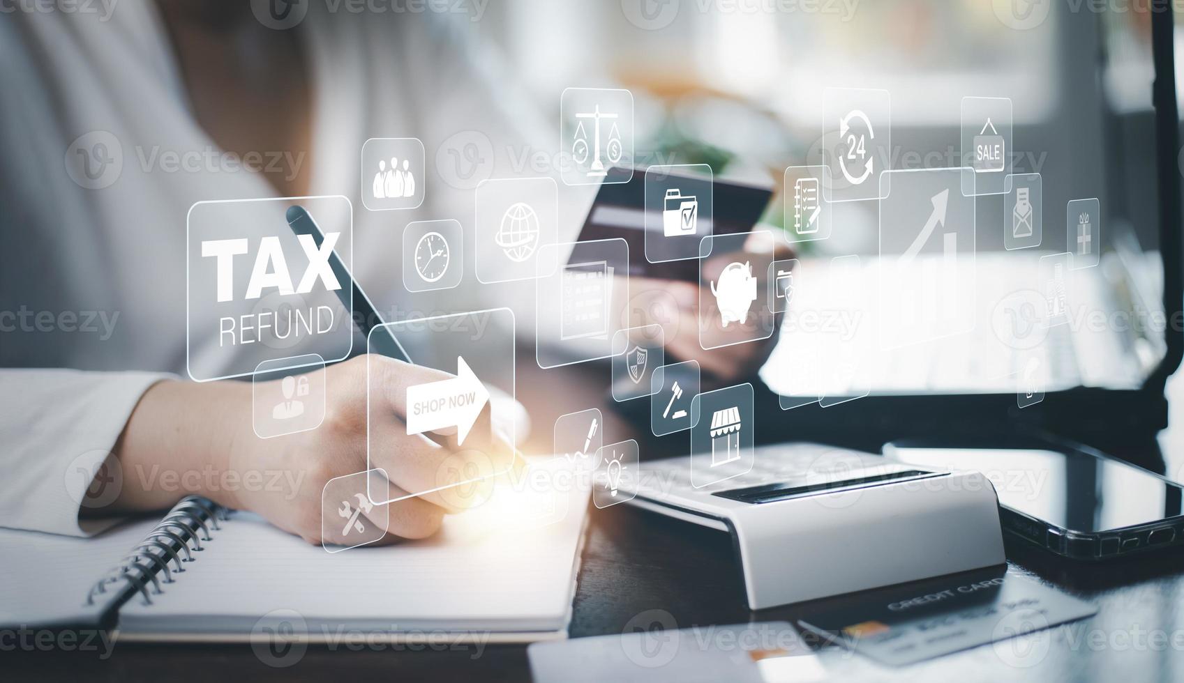 Concept of tax payment optimisation business finance,Man using calculator and taxes icon on technology screen,income tax and property, background for business, individuals and corporations such as VAT photo