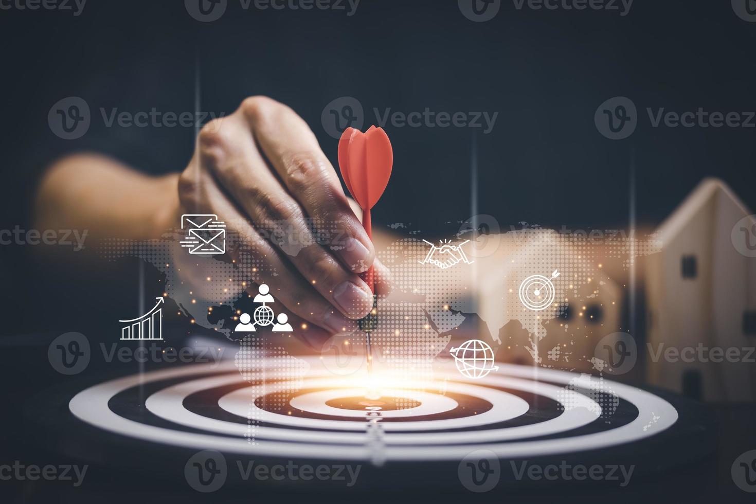 Targeting the business concept, Businessman hand holding red dart to the virtual target dartboard, Executive marketing, investment goal and target for business investment concept, photo