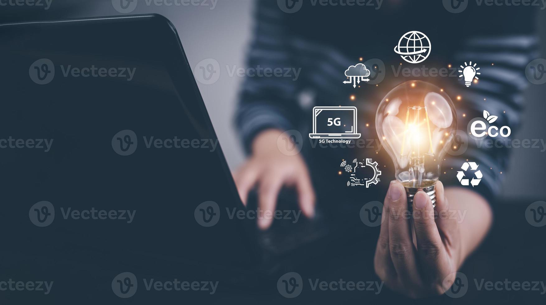 Man hand hold light bulb with icons work on the desk, Creativity and innovation are keys success. Concept of new idea and innovation with icons and light bulbs, Save the money, Freedom of thought. photo