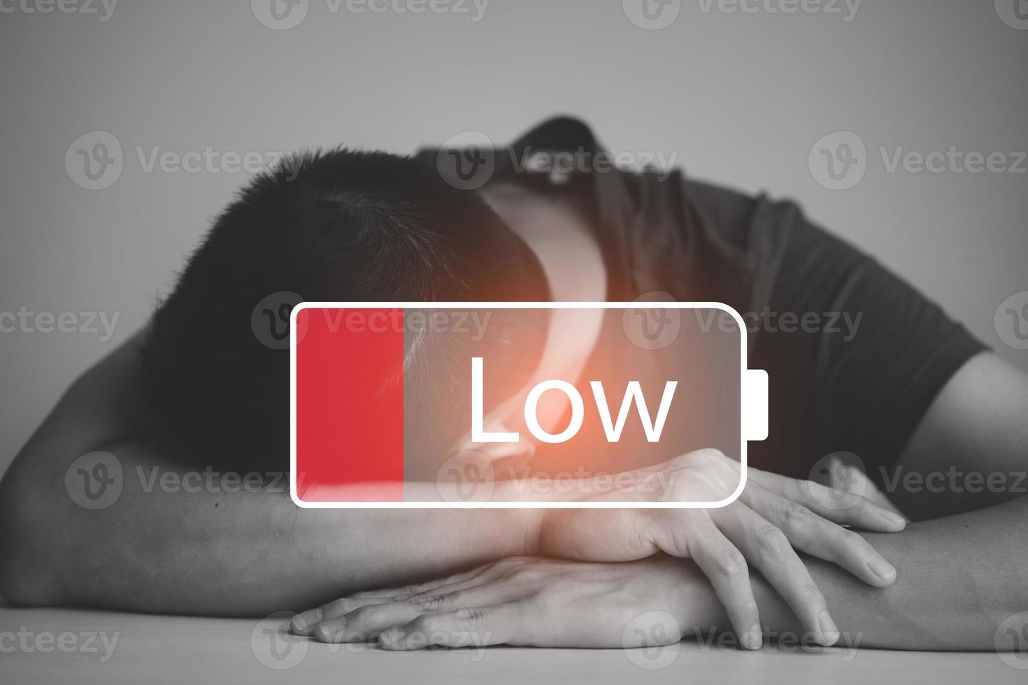 Businessman pressing button Low battery of energy with people icon concept, Saving on working with empty battery symbol,Tired from work and stress concept, Empowering ideas and teamwork photo