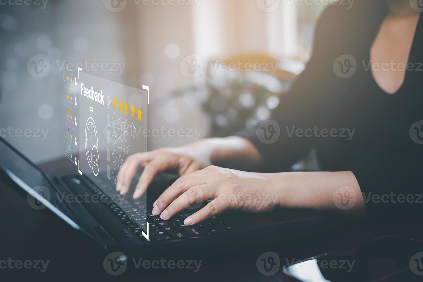 Woman using laptop with Customer review satisfaction feedback survey concept, User give rating to service experience on online application, service leading to reputation ranking of business. photo
