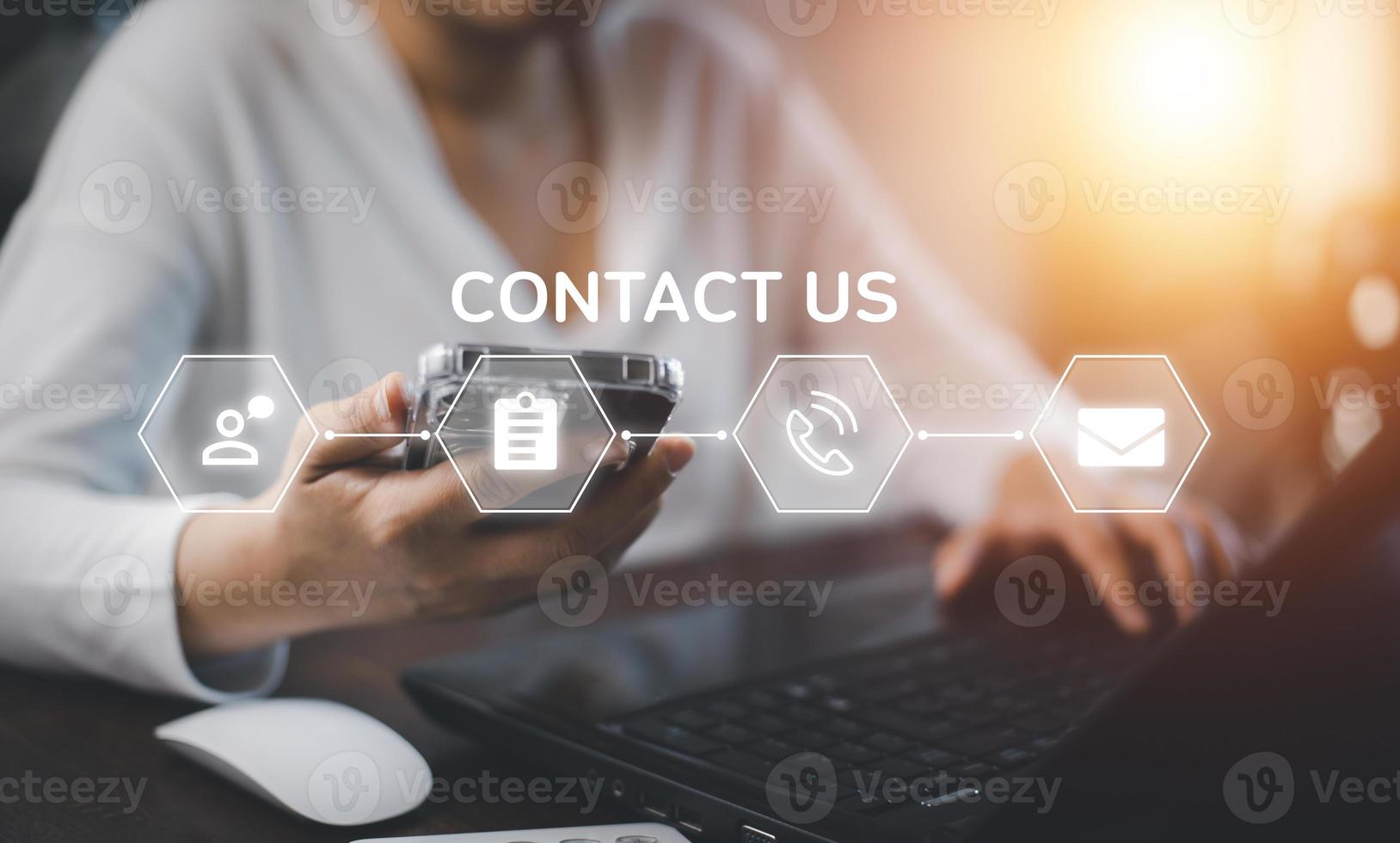 Communication and Contact us or Customer support hotline people connect. Hand using a laptop and touching on virtual screen contact icons, email and address, live chat with internet wifi. photo