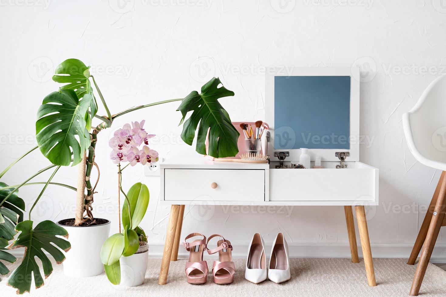Stylish room interior with elegant dressing table and plants photo