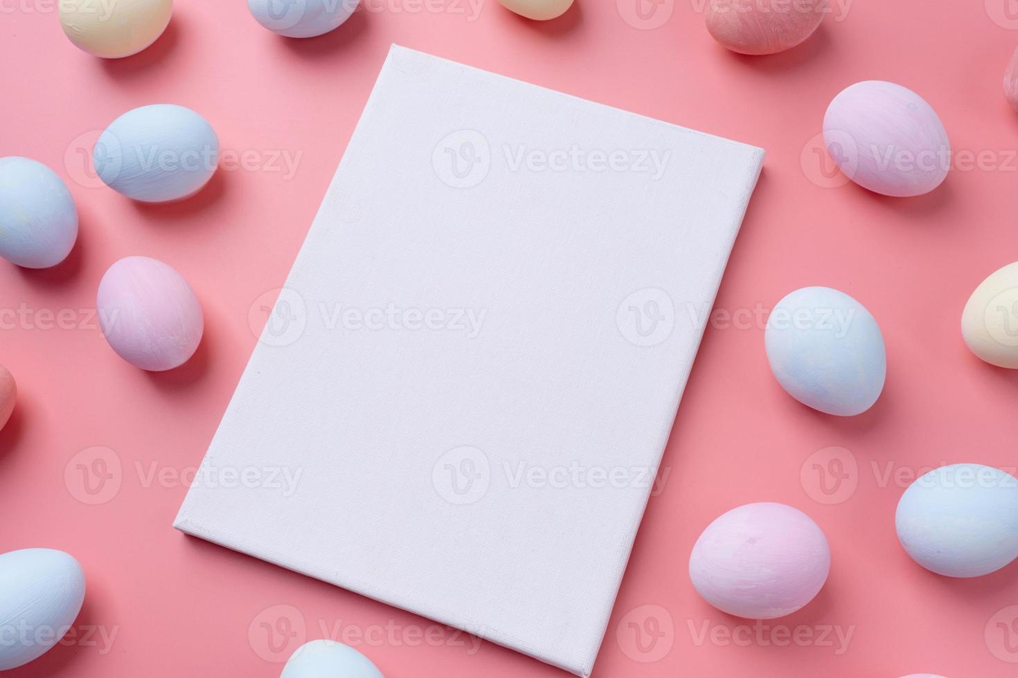 Pastel colored Easter eggs with blank white frame for mockup design photo
