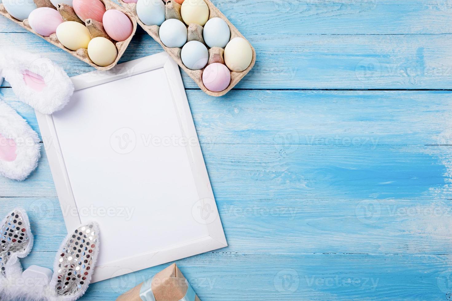 Pastel colored Easter eggs with blank white frame for mockup design photo
