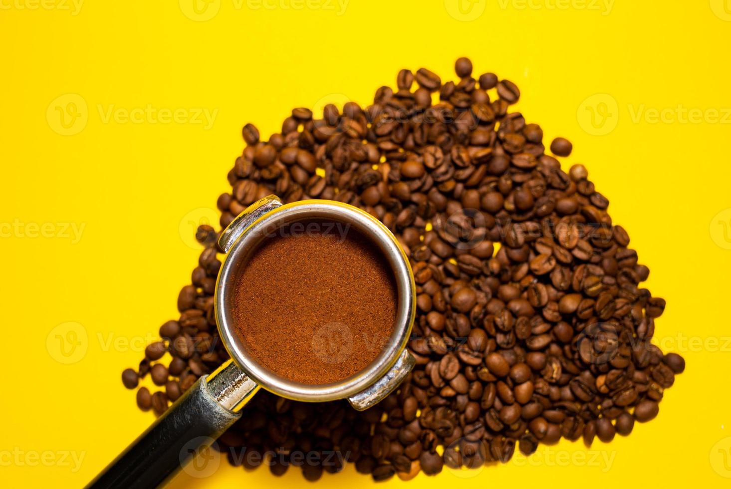 An open bag of fresh coffee beans. Holder filter with ground coffee for coffee machines. Selective focus. Close up. photo