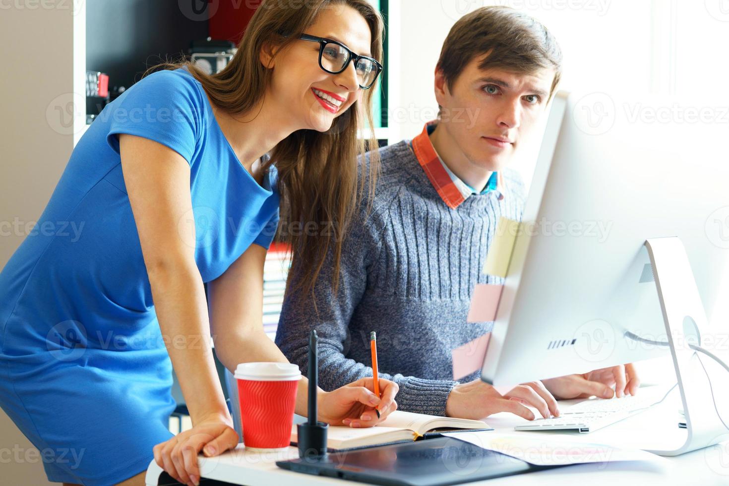 Beautiful young woman and man working from home office photo