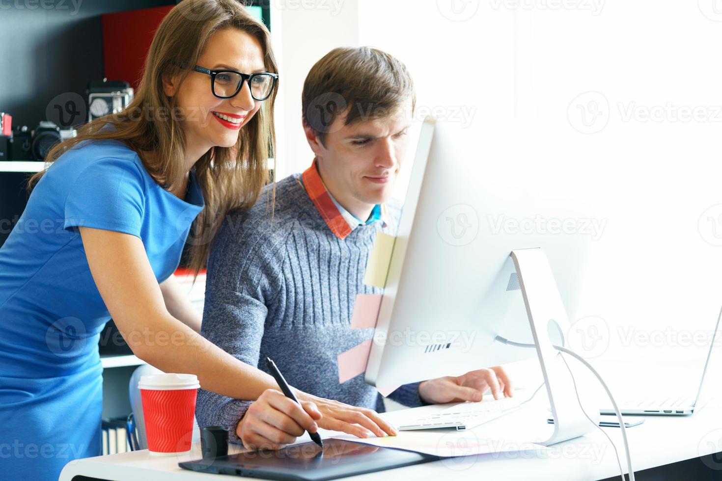 Beautiful young woman and man working from home office photo