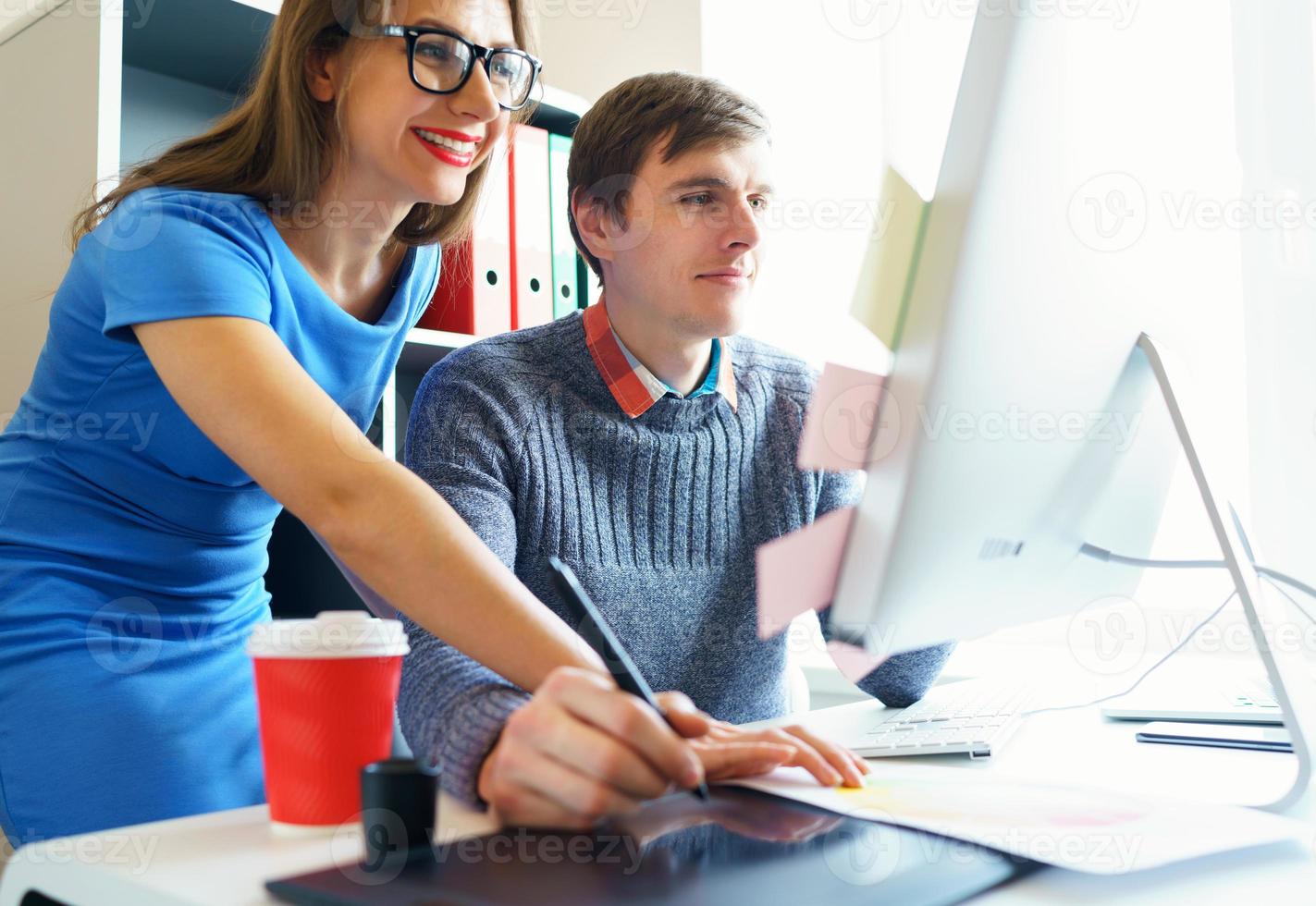 Beautiful young woman and man working from home office photo