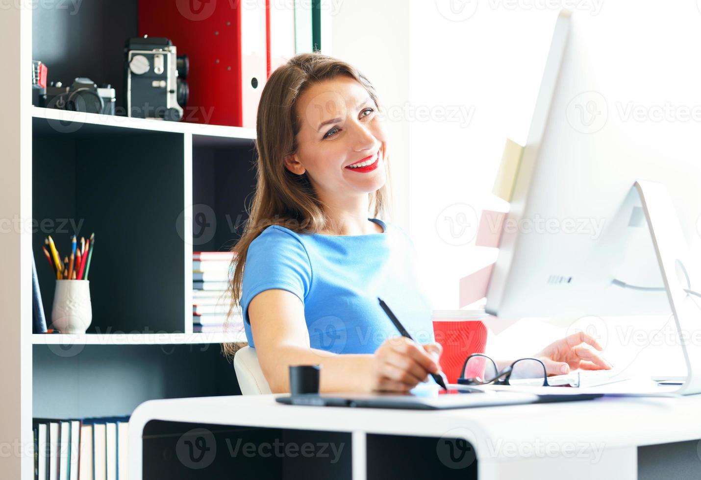 Graphic designer drawing something on graphic tablet at the home office photo