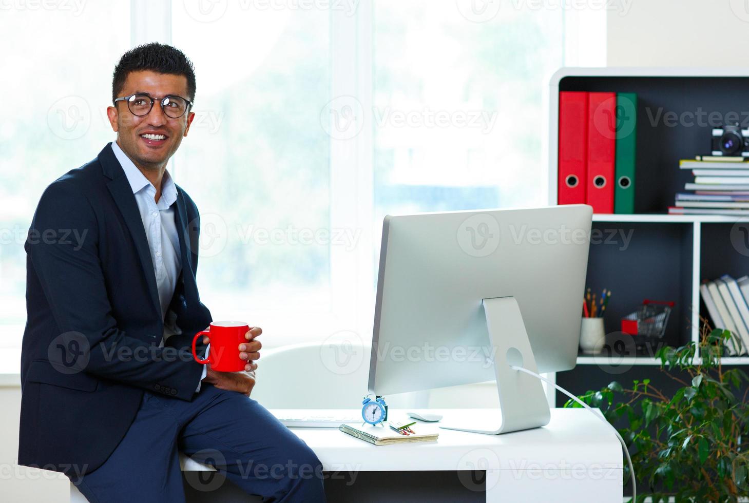 Handsome young man working from home office photo