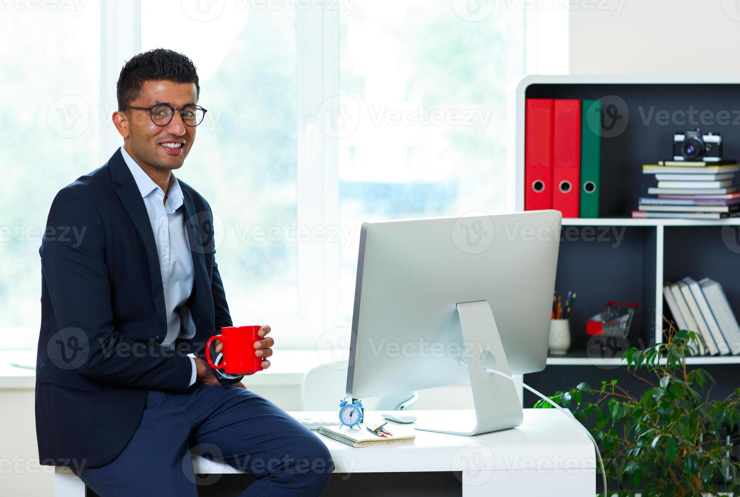 Handsome young man working from home office photo