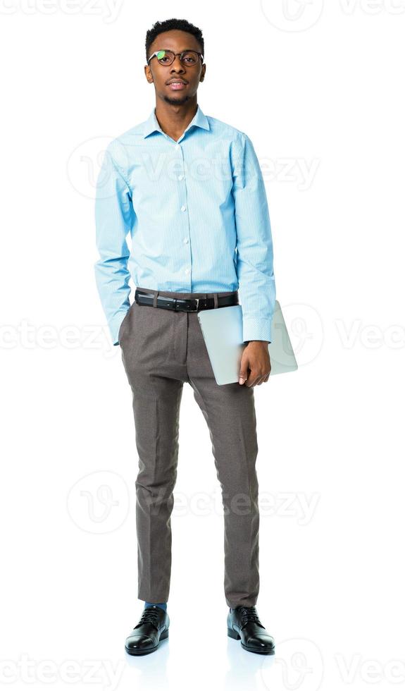 Happy african american college student standing with laptop on white photo