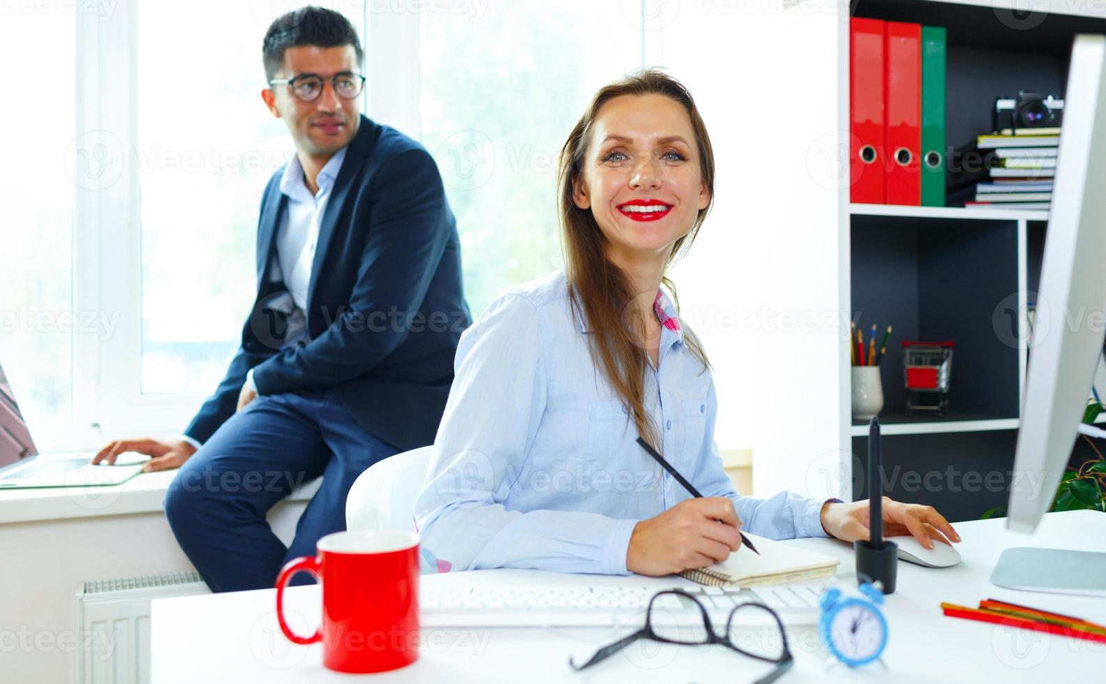 Beautiful young woman and man working from home photo