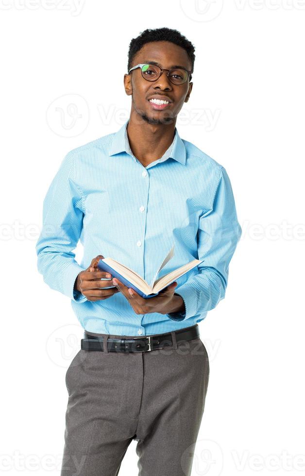 Happy african american college student standing with book on white photo