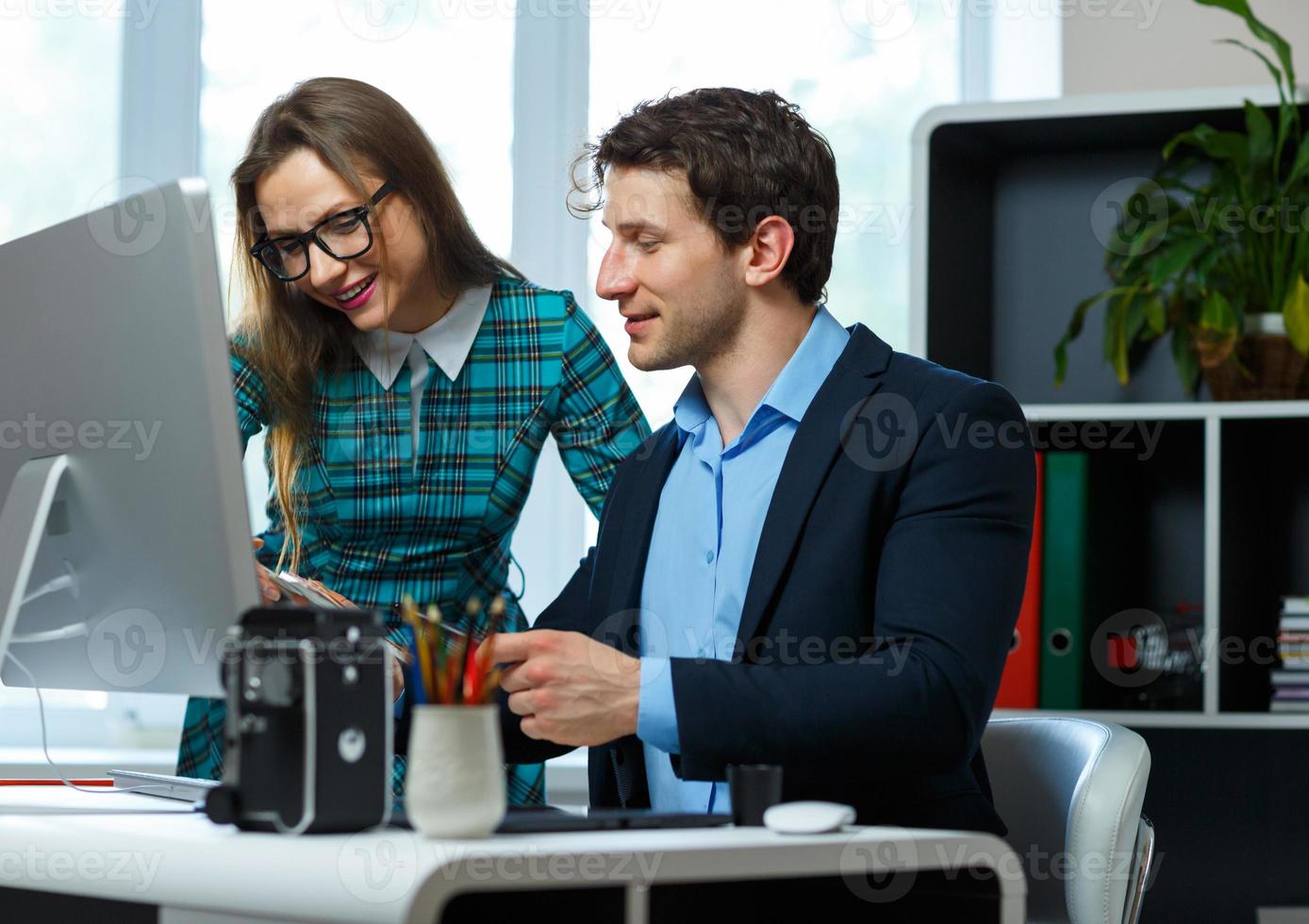 Beautiful young woman and man working from home photo