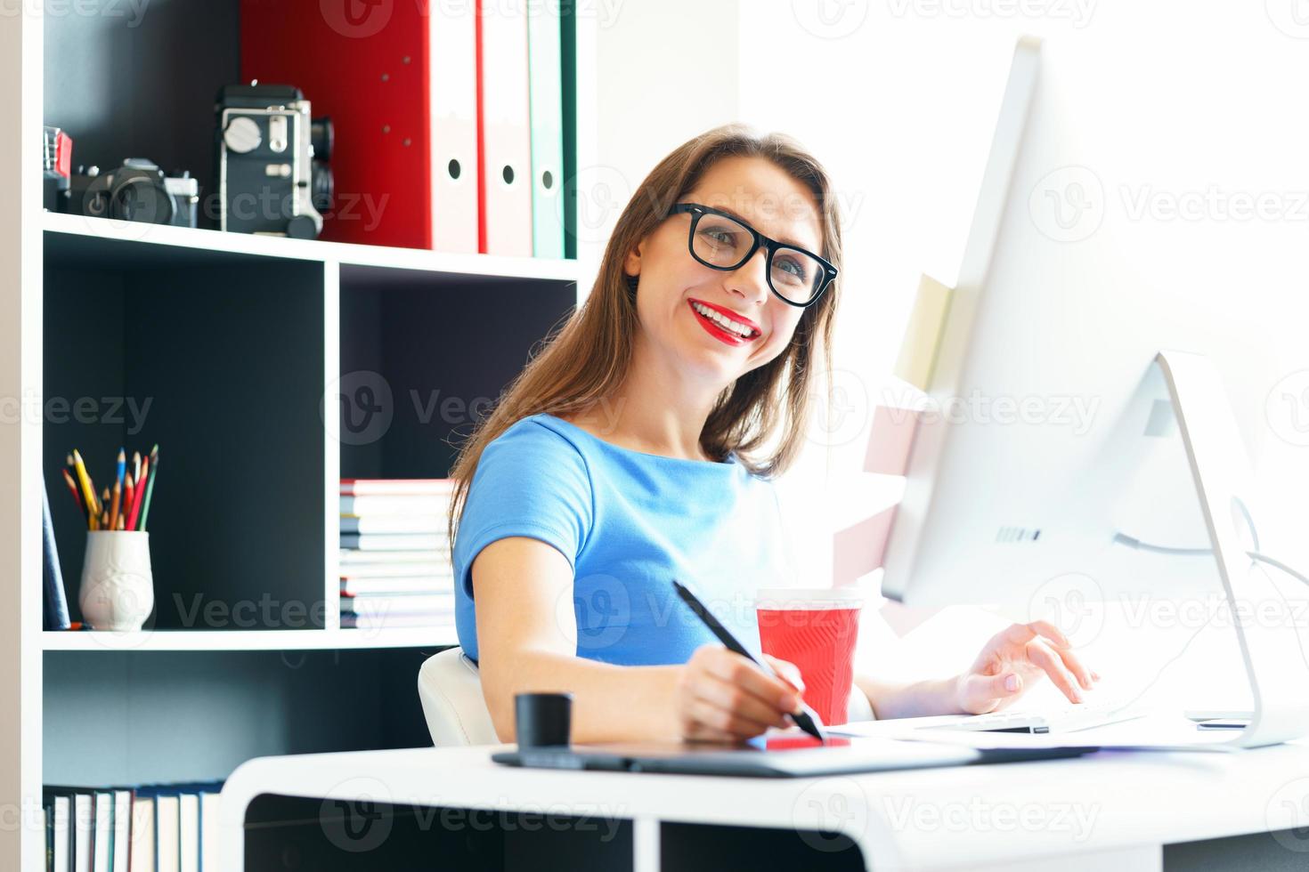 Graphic designer drawing something on graphic tablet at the home office photo