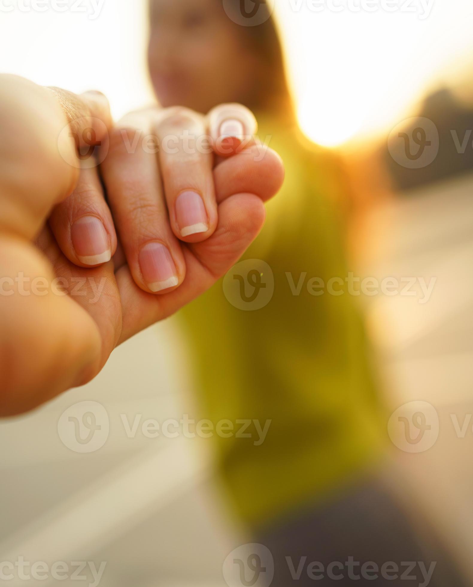 Happy young woman pulling guy's hand hand in hand walking on a bright sunny day 21060483 Stock
