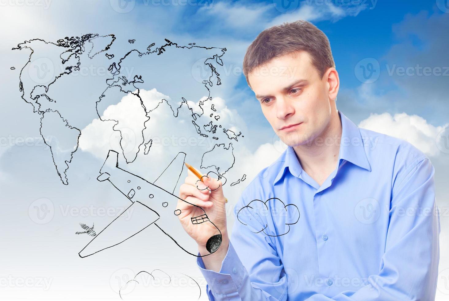 Businessman drawing plane and world map photo