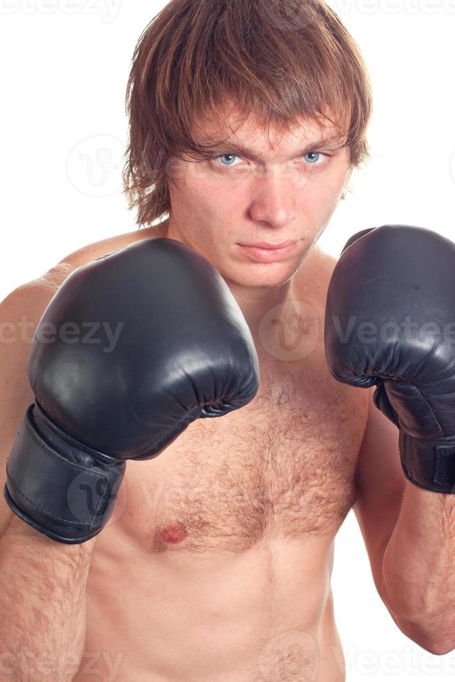 Young caucasian Man boxer with black boxing gloves. photo