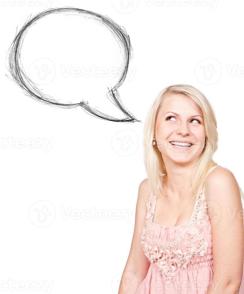 Happy blonde girl standing near blank speech bubble photo