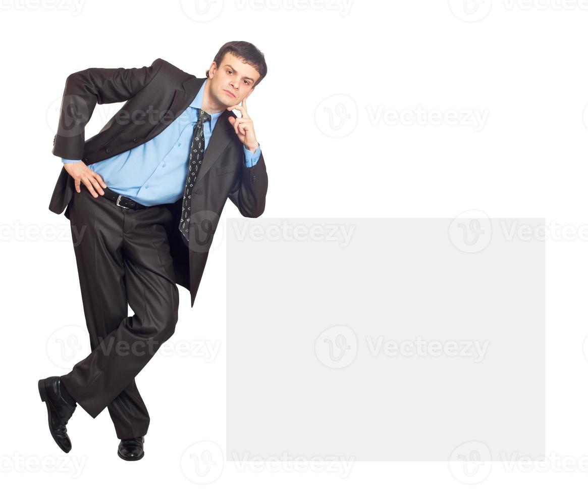 Portrait of young businessman and blank sign board photo