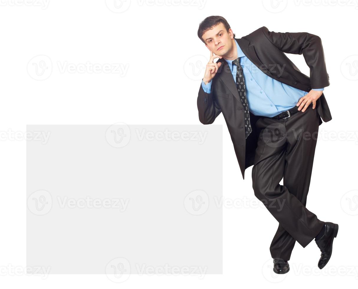 Portrait of young businessman and blank sign board photo