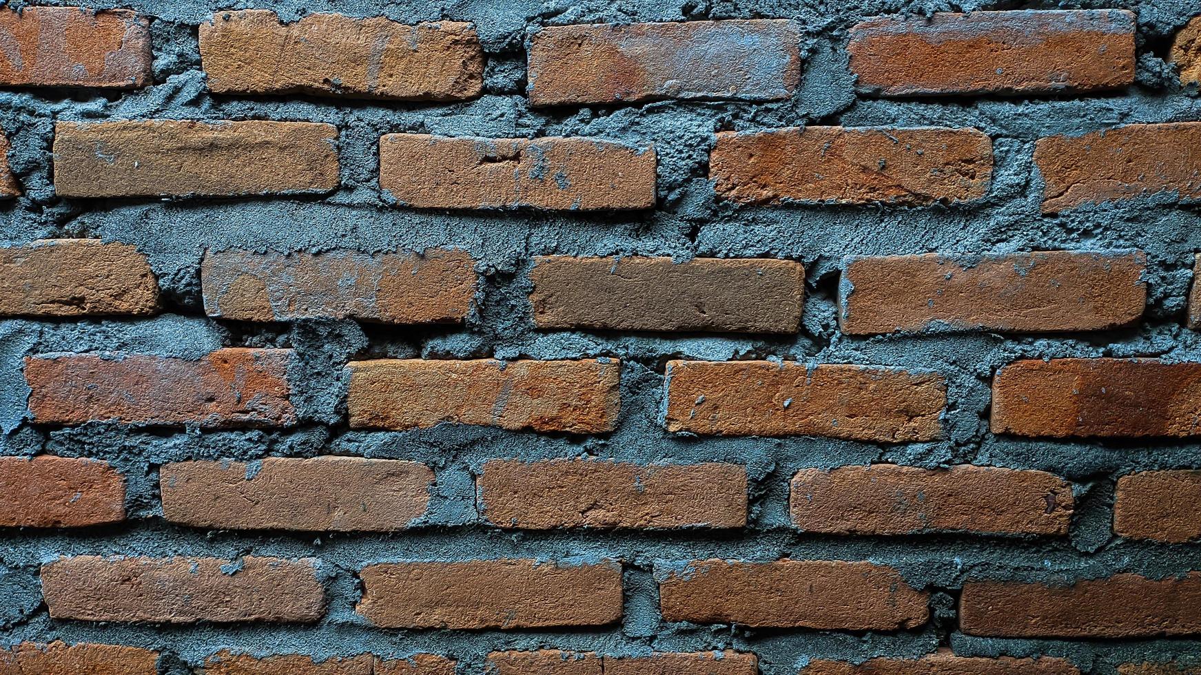 Brick wall with cement and messy arrangement. For backdrops and wallpapers. Empty space, vintage, no people. photo