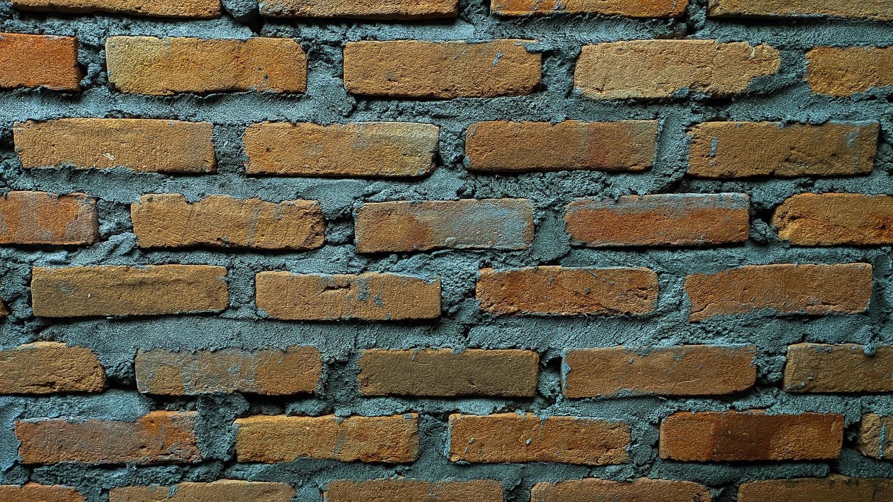 Brick wall with cement and messy arrangement. For backdrops. Empty space, no people. photo