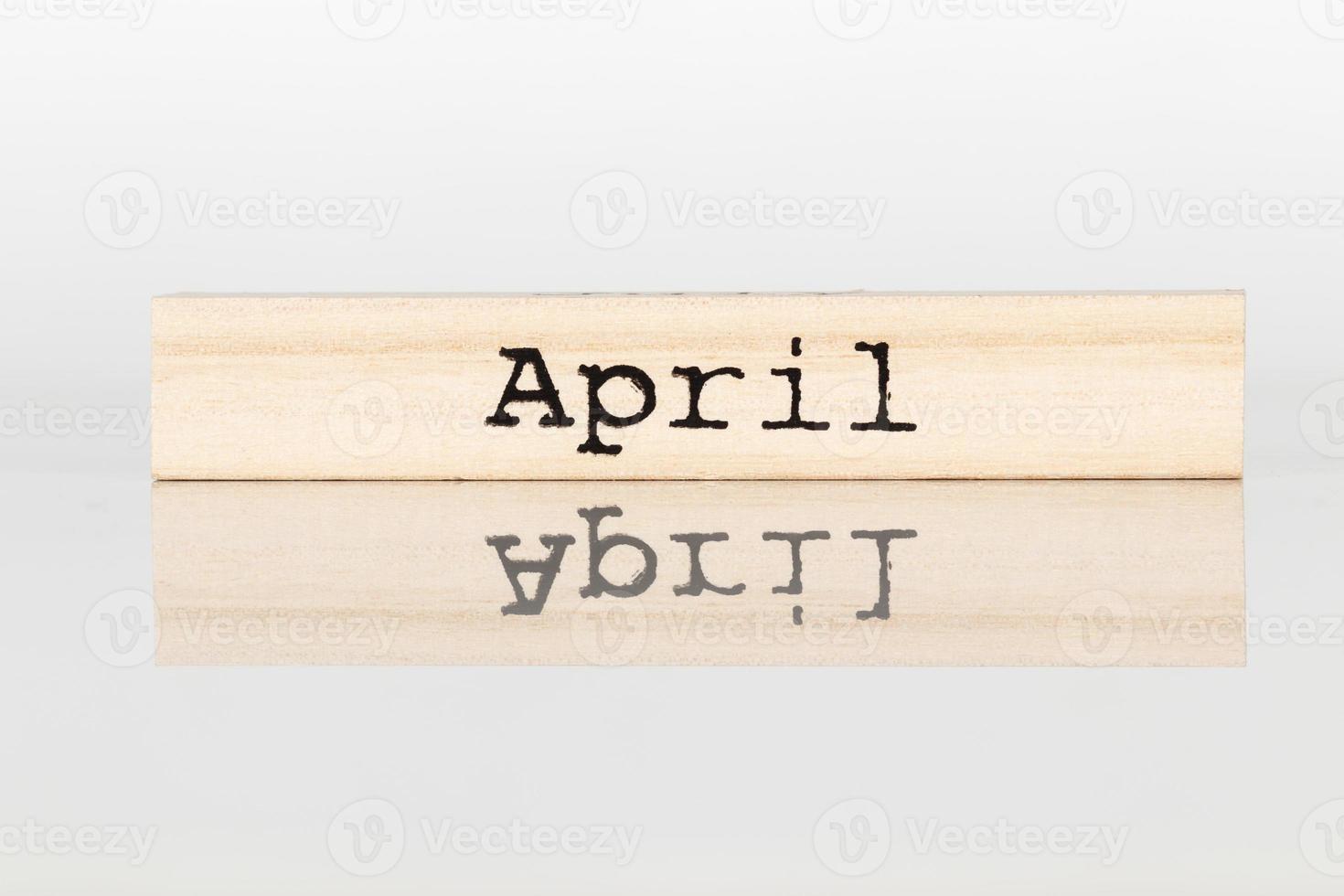 wooden cube with an inscription April on a white background photo