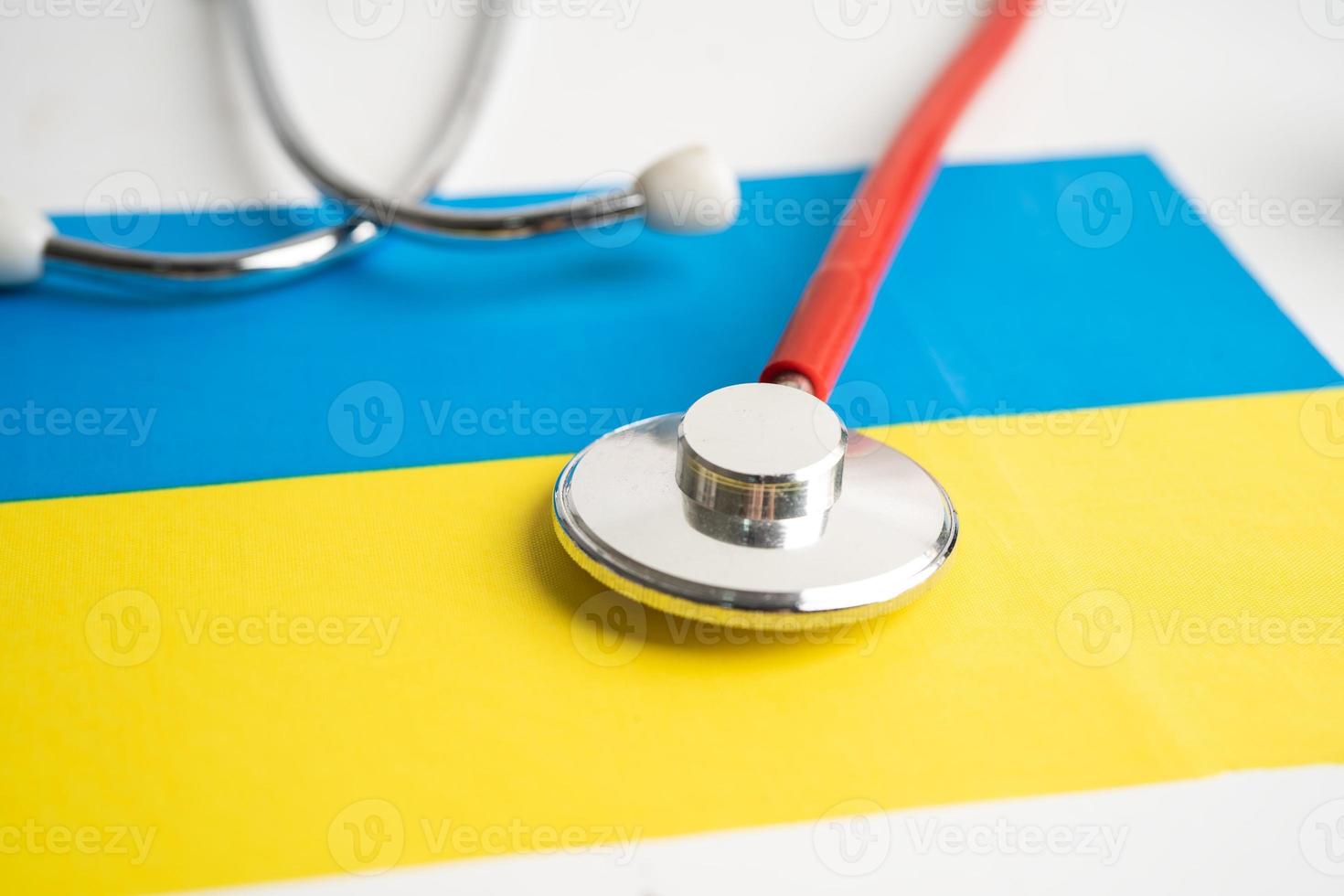 Red stethoscope on Ukraine flag background, Business and finance concept. photo