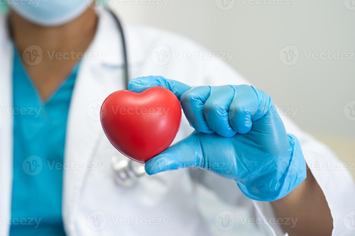 Doctor holding red heart, healthy strong medical concept. photo