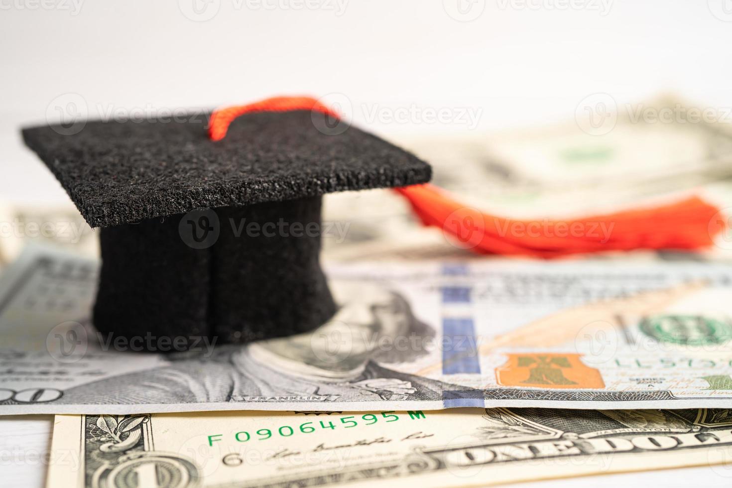 Graduation gap hat on Euro and US dollar banknotes money, Education study fee learning teach concept. photo
