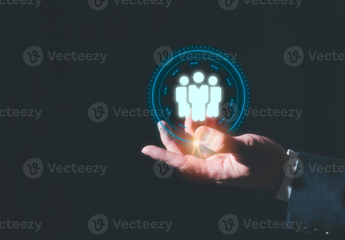 concept of team work drive to succeed in organisation, businessman holding vitual people icon show staff in team is important in company photo